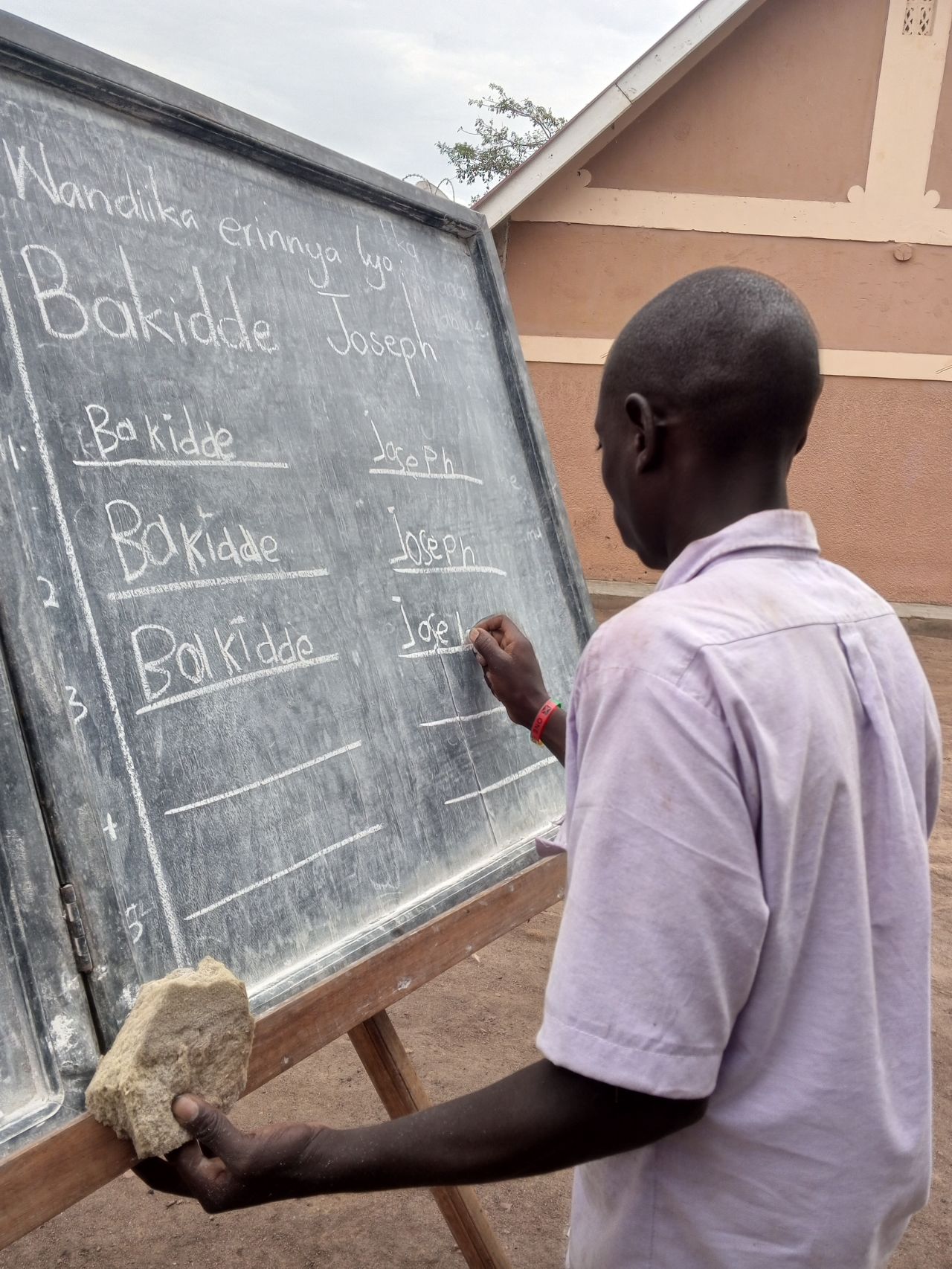 Mr Jpseph practicing how to write his name